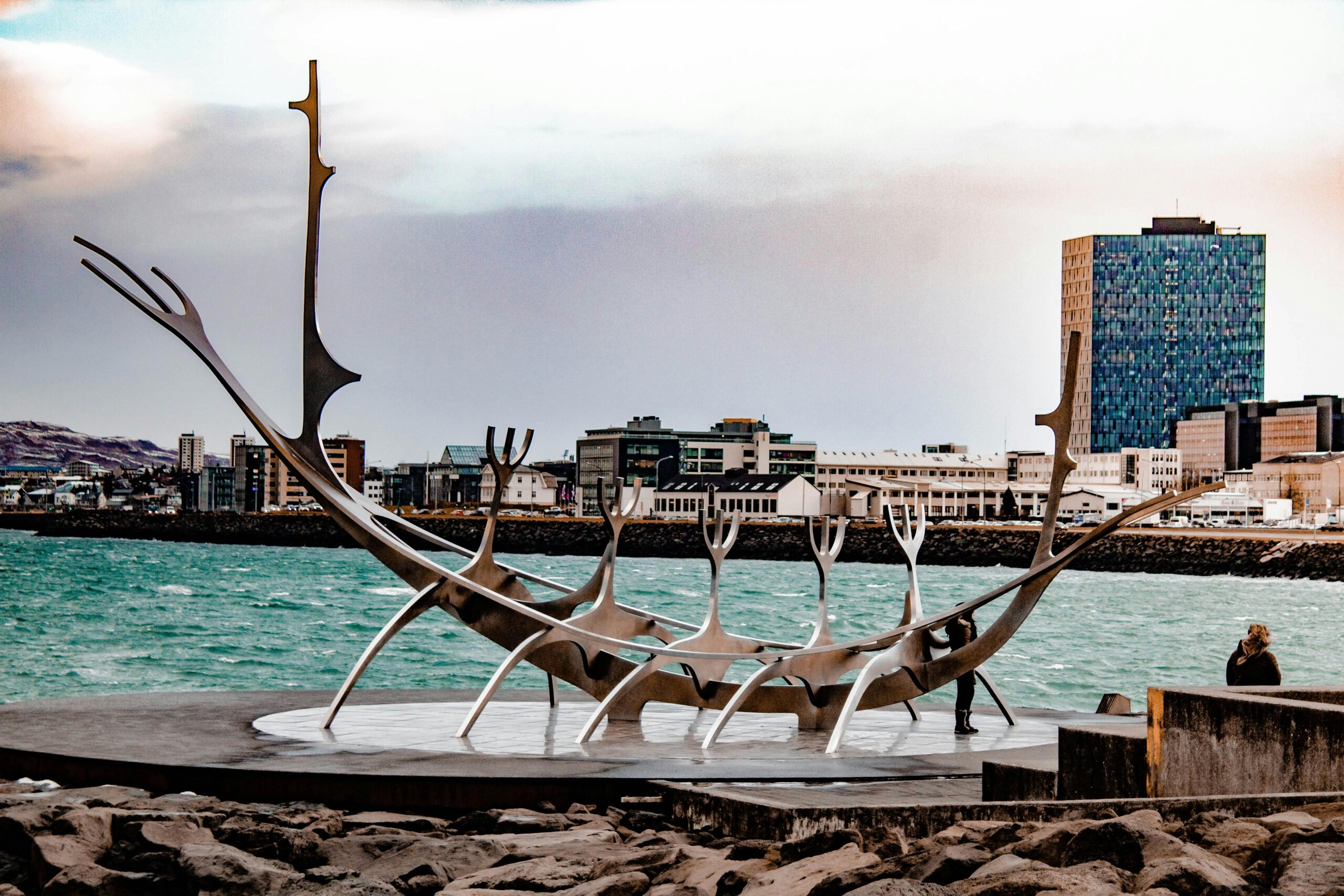The iconic Sun Voyager sculpture in Reykjavik with the city skyline in the background.
